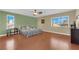 Spacious bedroom featuring a ceiling fan, light walls, and hardwood flooring at 9852 Snowy Canyon Ct, Las Vegas, NV 89183