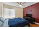 Bedroom with a full-size bed, ceiling fan, and accent wall at 9852 Snowy Canyon Ct, Las Vegas, NV 89183