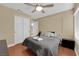 Cozy bedroom featuring light walls, wood floors, and a ceiling fan at 9852 Snowy Canyon Ct, Las Vegas, NV 89183