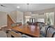 Elegant dining room with a wooden table, overlooks living room at 9852 Snowy Canyon Ct, Las Vegas, NV 89183