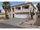 Two-story house with a three-car garage and desert landscaping at 9852 Snowy Canyon Ct, Las Vegas, NV 89183