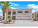 Inviting two-story home featuring a balcony, three-car garage, and mature palm tree at 9852 Snowy Canyon Ct, Las Vegas, NV 89183