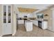 A well-lit kitchen featuring white cabinetry, a center island, and plenty of storage space at 9852 Snowy Canyon Ct, Las Vegas, NV 89183