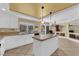 Spacious kitchen with tile floors, white cabinets, and view of the pool and backyard at 9852 Snowy Canyon Ct, Las Vegas, NV 89183