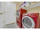 Modern laundry room with a front loading washer and dryer and plenty of storage space at 9852 Snowy Canyon Ct, Las Vegas, NV 89183