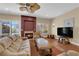 Inviting living room with wood floors, fireplace, and access to the outdoor pool area at 9852 Snowy Canyon Ct, Las Vegas, NV 89183