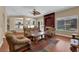 Comfortable living room with wood floors, fireplace, and a view of the pool at 9852 Snowy Canyon Ct, Las Vegas, NV 89183