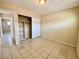 Bedroom with tile floors, mirrored closet, and access to a hallway at 99 N 21St St, Las Vegas, NV 89101