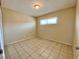 Well-lit bedroom featuring tile floors and a window at 99 N 21St St, Las Vegas, NV 89101