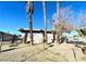 Ranch style home with a fenced yard and mature palm trees at 99 N 21St St, Las Vegas, NV 89101