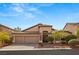 Single-story house with two-car garage, landscaping, and a brick facade at 10093 Golden Bluff Ave, Las Vegas, NV 89148