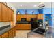 Modern kitchen with wood cabinets, granite counters, and sink at 10093 Golden Bluff Ave, Las Vegas, NV 89148