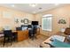 Home office with wood desk, two chairs, and large window at 10093 Golden Bluff Ave, Las Vegas, NV 89148