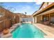 Inviting rectangular pool with a water feature and wooden deck at 10093 Golden Bluff Ave, Las Vegas, NV 89148