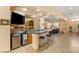 Curved wet bar with granite countertop and mini-fridge at 10093 Golden Bluff Ave, Las Vegas, NV 89148