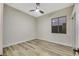 Comfortable bedroom, featuring wood-look floors and a ceiling fan at 10369 Niagara Falls Ln, Las Vegas, NV 89144