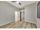 Well-lit bedroom with mirrored closet doors and wood-look floors at 10369 Niagara Falls Ln, Las Vegas, NV 89144