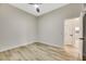 Spacious bedroom featuring wood-look floors and ceiling fan at 10369 Niagara Falls Ln, Las Vegas, NV 89144