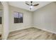 Bright bedroom with ceiling fan and wood-look flooring at 10369 Niagara Falls Ln, Las Vegas, NV 89144