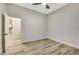 Spacious bedroom with wood-look floors and a ceiling fan at 10369 Niagara Falls Ln, Las Vegas, NV 89144