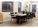 Modern dining room features a large concrete table with dark chairs and hardwood floors at 10369 Niagara Falls Ln, Las Vegas, NV 89144