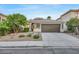 Single-story home with a two-car garage and well-manicured landscaping at 10369 Niagara Falls Ln, Las Vegas, NV 89144