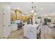 Modern kitchen with white cabinets, marble island, and stainless steel appliances at 10369 Niagara Falls Ln, Las Vegas, NV 89144