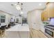 Modern kitchen with light wood cabinets, marble countertops, and stainless steel appliances at 10369 Niagara Falls Ln, Las Vegas, NV 89144