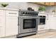 Stainless steel range with modern cabinetry and flooring in a contemporary kitchen at 10369 Niagara Falls Ln, Las Vegas, NV 89144