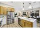 Open concept kitchen island with white quartz waterfall countertop at 10369 Niagara Falls Ln, Las Vegas, NV 89144