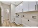 Clean laundry room featuring white cabinets and vinyl flooring at 10369 Niagara Falls Ln, Las Vegas, NV 89144