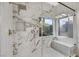 Spa-like shower with marble tile and built-in seat at 10369 Niagara Falls Ln, Las Vegas, NV 89144