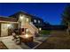 Night view of backyard with fire pit and seating at 108 Breeze Ct, Las Vegas, NV 89145