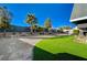 Artificial turf backyard with gravel and palm trees at 108 Breeze Ct, Las Vegas, NV 89145