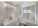 Updated bathroom with white vanity, subway tile, and tub at 108 Breeze Ct, Las Vegas, NV 89145