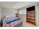 Cozy bedroom with a plaid comforter and a wood bookcase at 108 Breeze Ct, Las Vegas, NV 89145