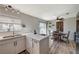 Modern kitchen with white cabinets, stainless steel appliances and an eat-in area at 108 Breeze Ct, Las Vegas, NV 89145