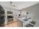 Bright kitchen boasts white cabinets, stainless steel appliances, and an L-shaped counter at 108 Breeze Ct, Las Vegas, NV 89145