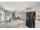 Modern kitchen with white cabinets, island, and view into dining area at 108 Breeze Ct, Las Vegas, NV 89145