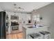 Updated kitchen featuring white cabinets, stainless steel appliances, and breakfast bar at 108 Breeze Ct, Las Vegas, NV 89145