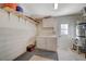 Bright laundry room with washer, dryer, and storage shelves at 108 Breeze Ct, Las Vegas, NV 89145