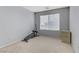 Bright bedroom with window and workout area at 10810 Hunters Green Ave, Las Vegas, NV 89166