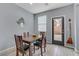 Bright dining area with wood table and access to backyard at 10810 Hunters Green Ave, Las Vegas, NV 89166