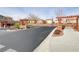 Community entrance with paved path and landscaping at 10810 Hunters Green Ave, Las Vegas, NV 89166