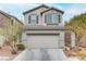 Two-story house with attached garage and landscaping at 10810 Hunters Green Ave, Las Vegas, NV 89166