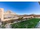 Landscaped backyard with mountain views and a fence at 11130 Red Yucca Dr, Las Vegas, NV 89138