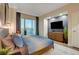 Serene bedroom with a king-size bed, stunning city views, and wood dresser at 125 E Harmon Ave # 3214, Las Vegas, NV 89109