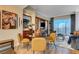 Bright dining area with four chairs and a round glass table, offering an open layout at 125 E Harmon Ave # 3214, Las Vegas, NV 89109