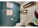 Stylish powder room with dark teal walls and floating shelves at 145 E Harmon Ave # 2120, Las Vegas, NV 89109