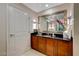 Elegant bathroom with dark wood cabinets and a large mirror at 145 E Harmon Ave # 2120, Las Vegas, NV 89109